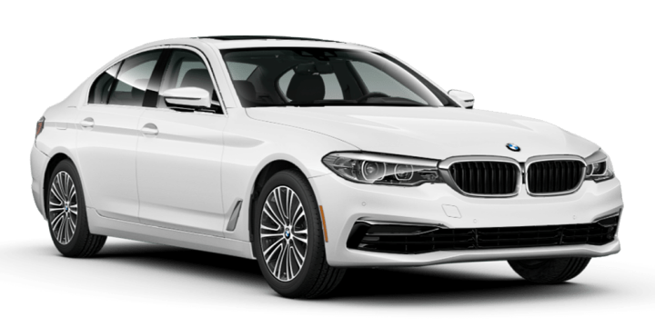 A BMW 330i parked on white sand.