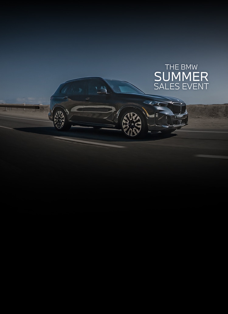 Dynamic shot of the 2026 X5 xDrive50e SUV cruising down the highway.