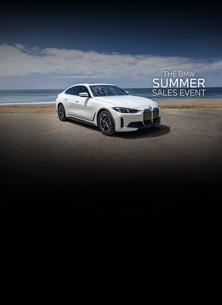 Front angle shot of the 2025 i4 eDrive40 Gran Coupe parked at the beach on a sunny day