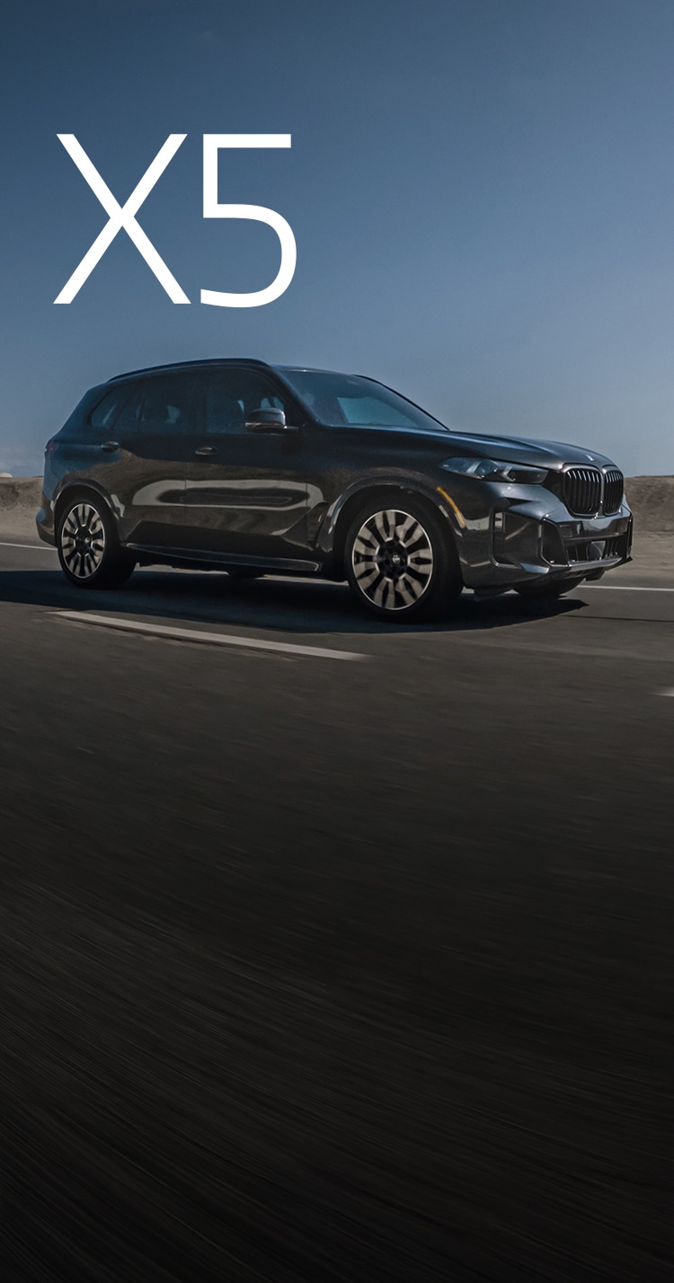 Dynamic shot of the BMW X5 xDrive50e driving down a highway.