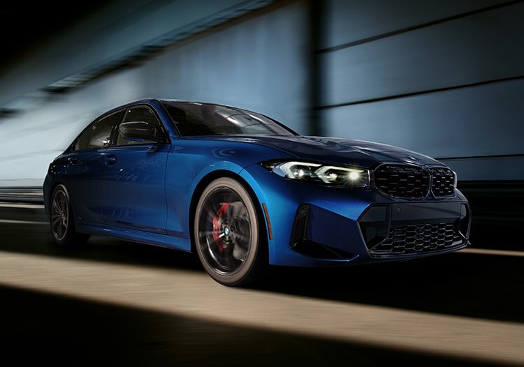 Low side angle of a 2024 BMW M340i in a dark tunnel