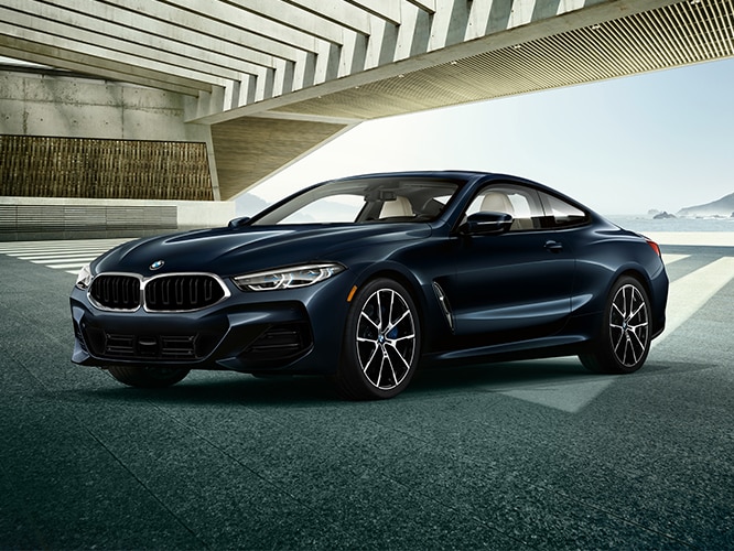 2025 BMW 840i Coupe parked in an open garage with light streaming in