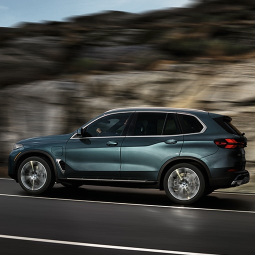 Dynamic shot of the BMW X5 SUV cruising down a highway