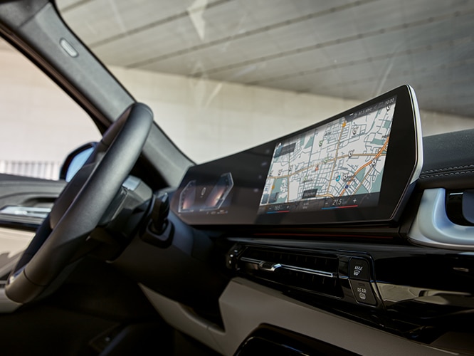 Detail shot of the new Curved Display arching across the dashboard of the 2023 BMW X1 SAV