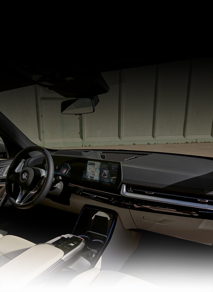 Interior shot of the 2023 BMW highlighting the new Curved Display, floating center console, and luxurious SensaTec upholstery