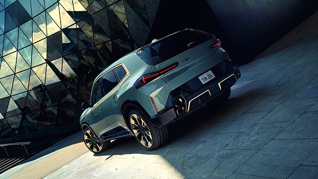 Side-to-rear angle of the BMW XM, showcasing first-ever vertical quad exhaust