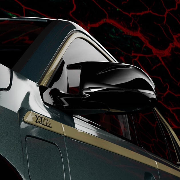 Detail of high-gloss black M mirrors set against a background image with an abstract lava pattern