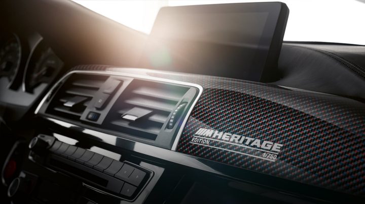 Detail of M colors interwoven into carbon fiber interior trim on M4 Edition M Heritage coupe