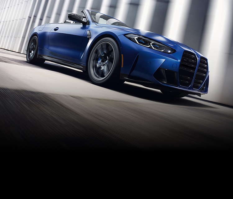 The 2022 BMW M4 Convertible accelerates through a cityscape