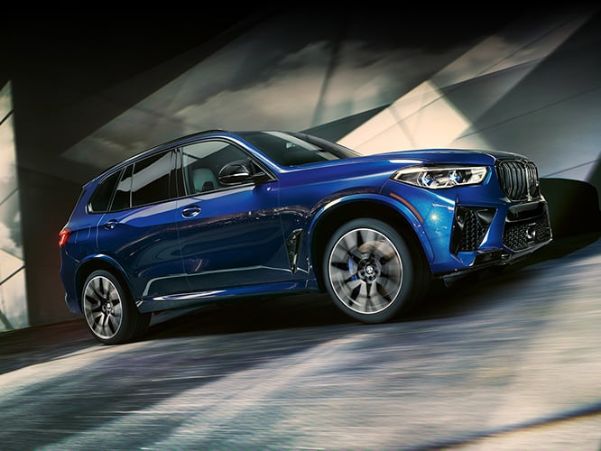 The BMW X3 M displays its stunning swagger against an angular, shadowy backdrop