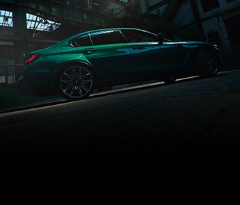 Side view of 2021 BMW M3 Sedan parked in an industrial building