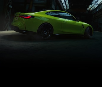 2021 BMW M4 Coupe making a turn inside an industrial building 