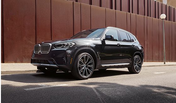 A BMW Certified X3 xDrive30i parked in front of a modern building