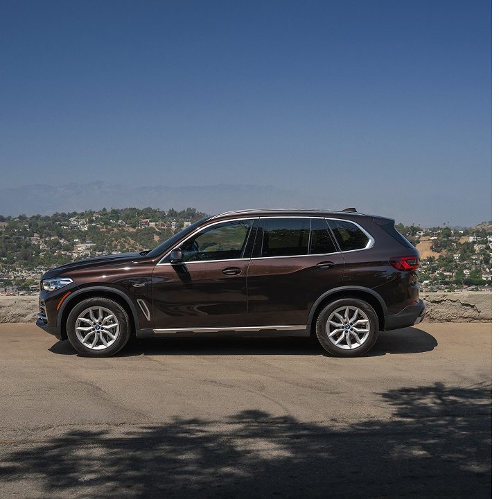 Profile shot of the BMW Certified X5 plug-in hybrid parked at a scenic overlook
