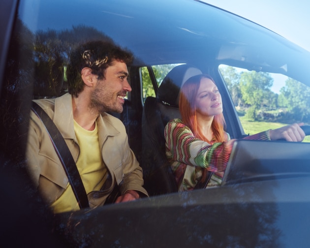 A couple in the driver and passenger's seats