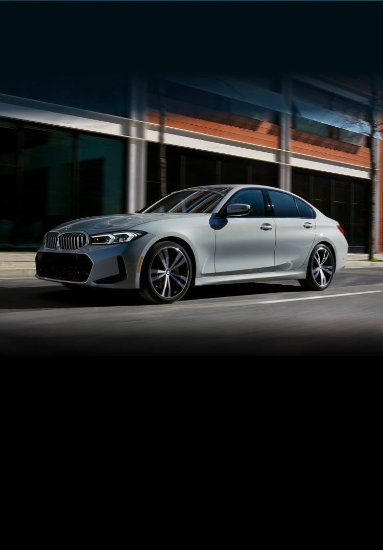 A BMW 3 Series Sedan driving down a city street