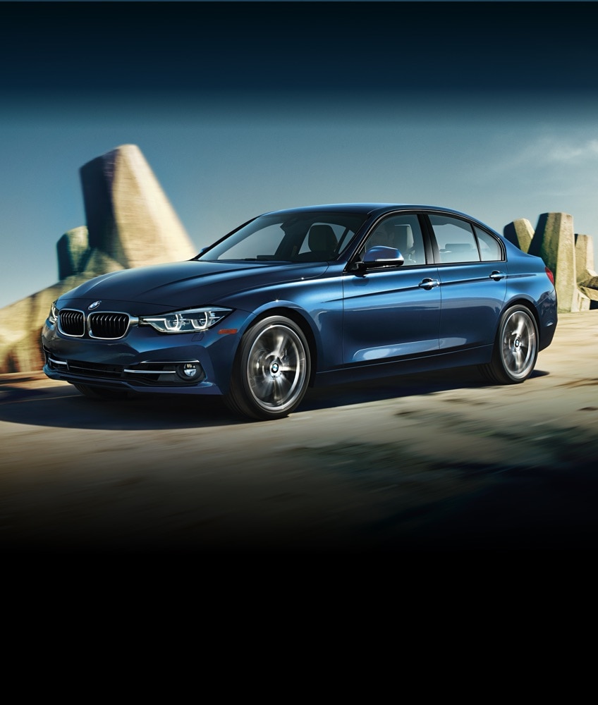 Side shot of a BMW 3 Series Sedan in Phytonic Blue Metallic driving down an open road