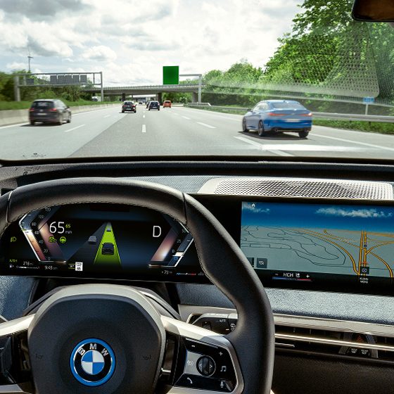 Interior shot of a person's hands on the steering wheel demonstrating Driving Assistant Plus features