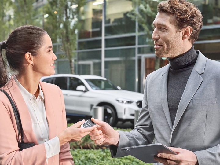 A BMW parked next to a scenic ocean