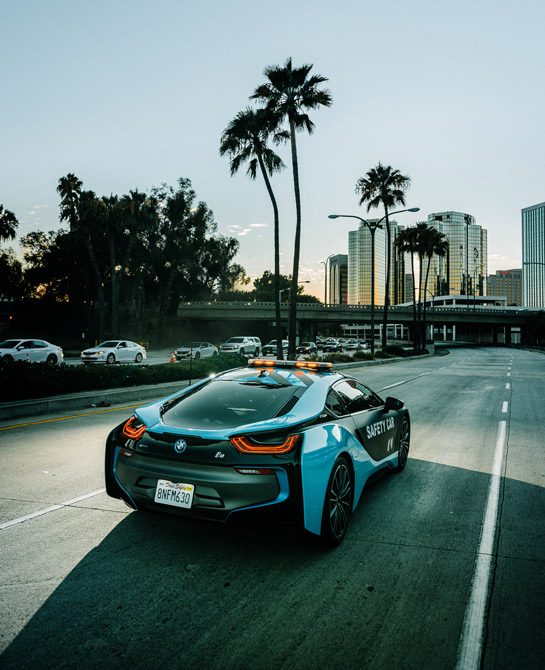 The BMW i8 FormulaE Saftety Car waits by a busy road