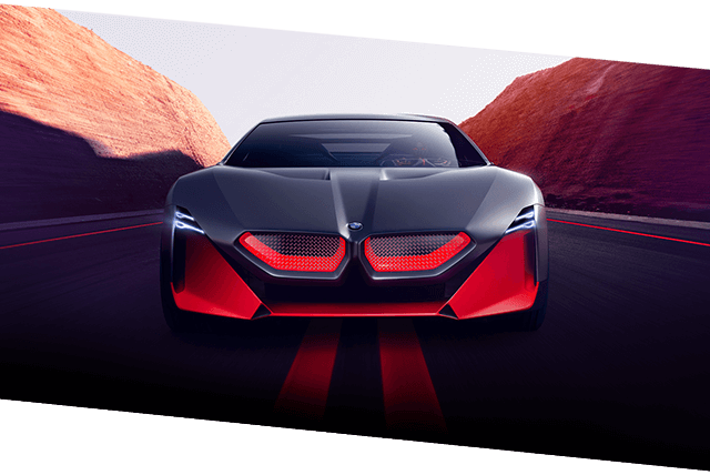 Front view of BMW Vision M Next speeding through a canyon