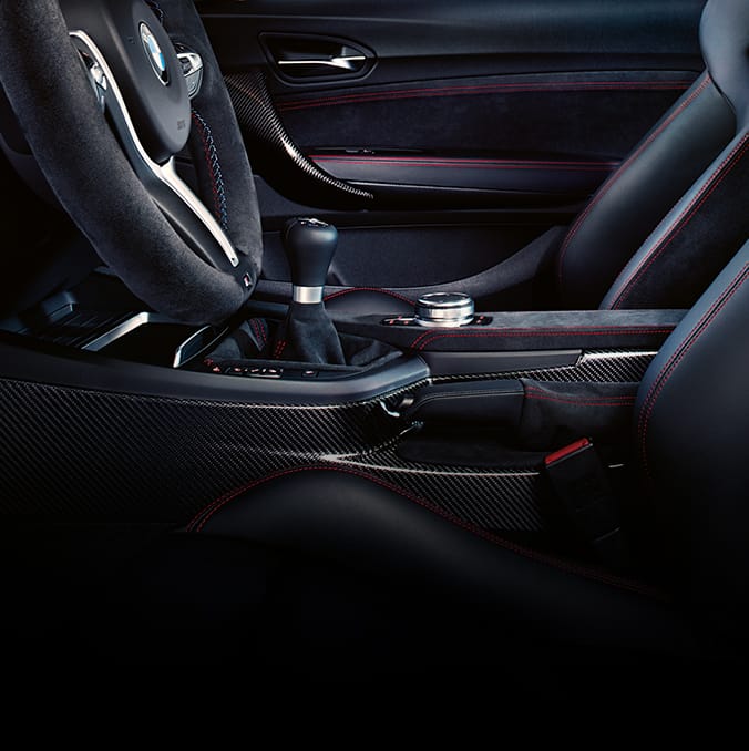 Detail of the carbon fiber center console and the carbon fiber door handles in the Limited Edition M2 CS