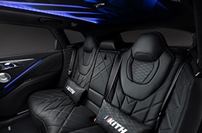 Rear passenger seats of the BMW XM by Kith featuring plush cushioning and Kith logo