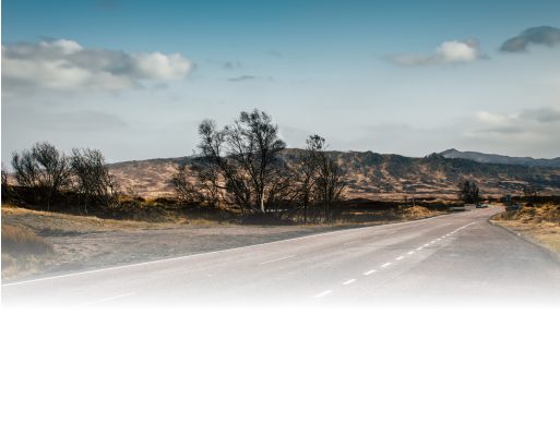 A three-quarter shot of the 2026 BMW X1 xDrive28i in front of a mountain road background