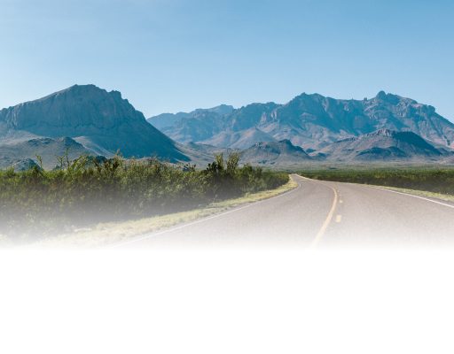 A three-quarter shot of the 2026 BMW X5 xDrive40i in front of a mountain road background