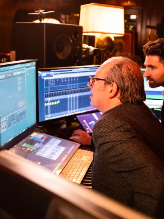 Hans Zimmer and BMW's Renzo Vitale look at a set of screens as they collaborate onsound design for the BMW i5