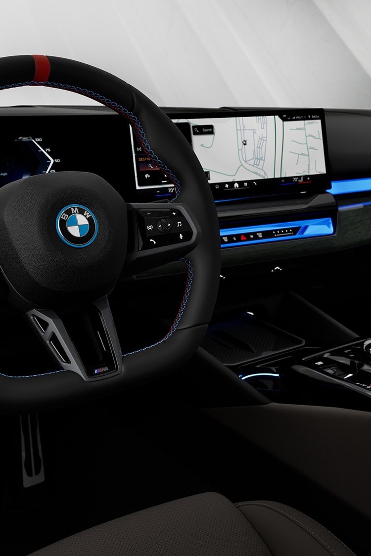 Close up of the BMW i5 M60 dash, featuring the BMW Curved Display and Interaction Bar