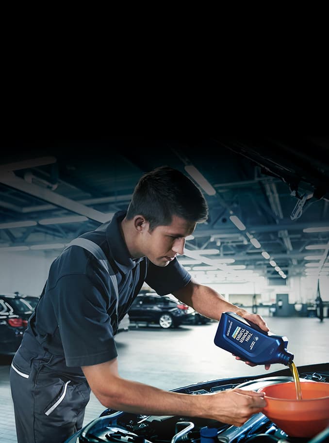 BMW Technician changing the oil of a BMW TwinPower engine