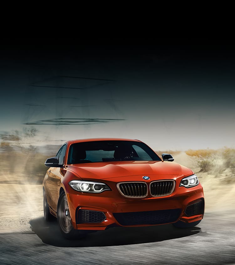 Red BMW showing off its performance capabilities on the road