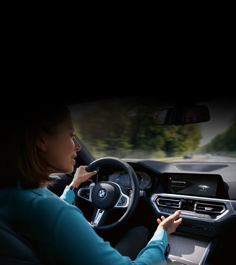 BMW driver using the features inside her BMW