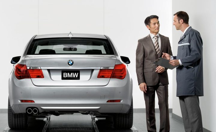 A customer speaks to a representative at a BMW Center