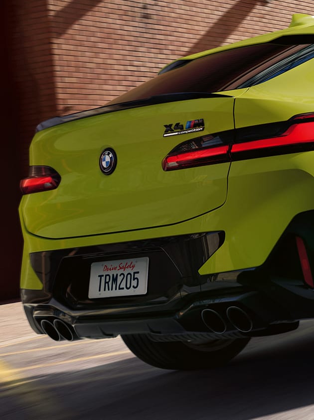 Detail shot of the quad exhaust system on a BMW X4 M in Sao Paolo Yellow