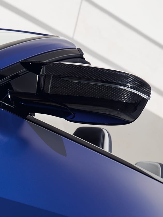 Detail shot of the bold mirror on a BMW M4 Competition xDrive Convertible
