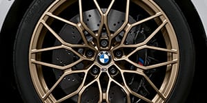 Detail shot of the BMW M wheel with gold wheel spokes