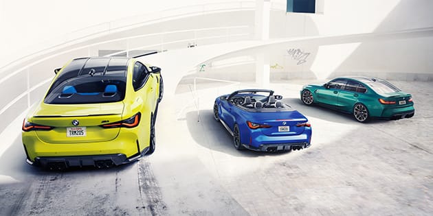 The 2022 M4 Competition Coupe, M4 Competition xDrive Convertible, M3 Competition Sedan parked along side one another