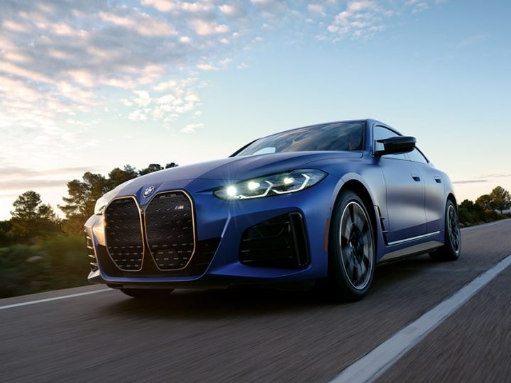 The BMW i4 M50 Gran Coupe accelerates down a highway