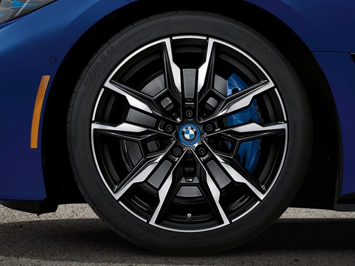 Detail of blue-caliper M Sport brakes and 19 inch M wheels in the BMW i4 M50 Gran Coupe