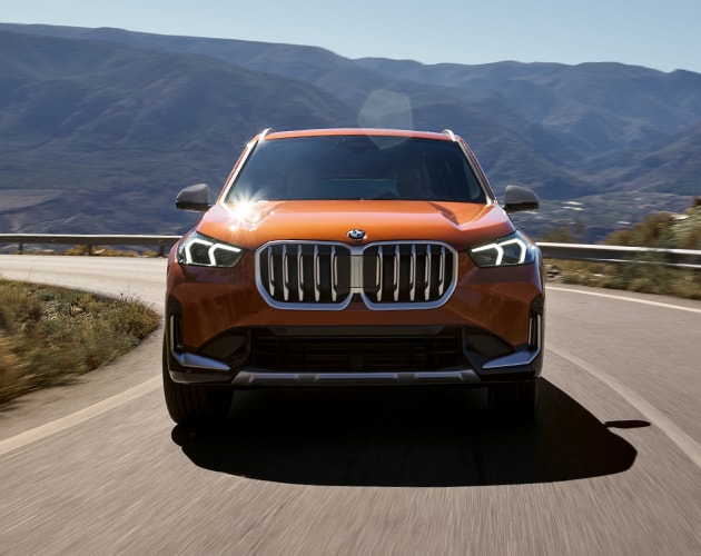 The BMW X5 xDrive50e Plug-in Hybrid charges at a home charging station