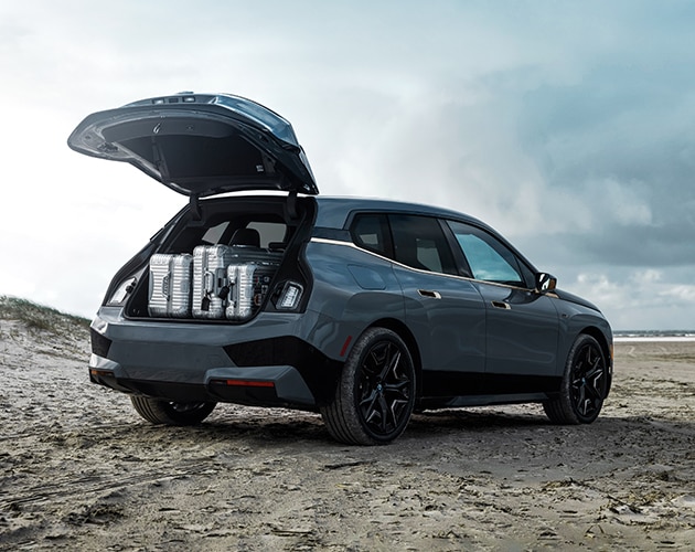 Interior of a BMW iX featuring split-fold down rear seats and voluminous cargo space