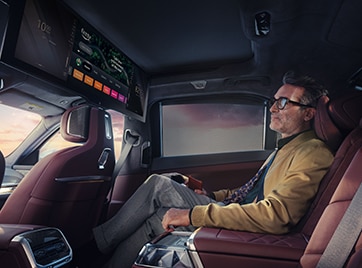 A passenger enjoys the BMW Theater Screen from the rear seat of the 2025 BMW 7 Series Sedan
