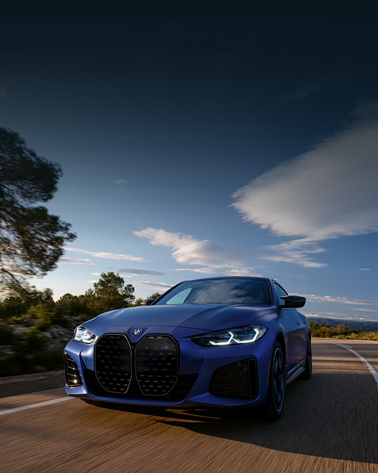 A BMW i4 M50 Gran Coupe takes a corner with precision handling