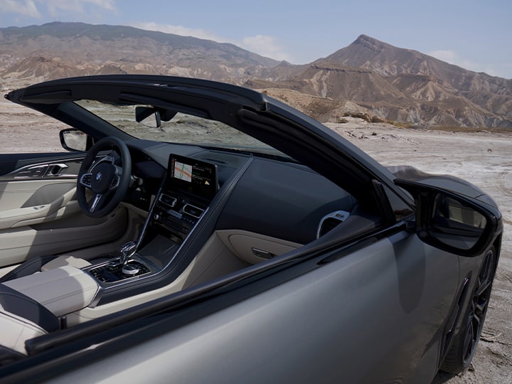 Looking in the passenger side window of a 2026 BMW 8 Series Convertible
