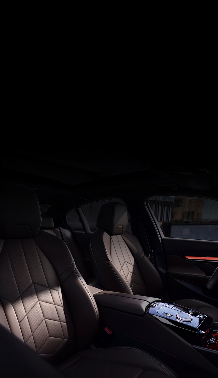 Interior detail of BMW i5 cockpit featuring seats with quilted Veganza upholstery