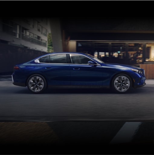 Side shot of the BMW 5 Series Sedan parked driving on an urban street