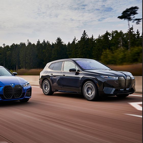 Side view of the BMW i4 and BMW iX on the open road
