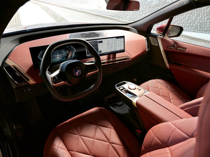Detail of steering wheel, Curved Display, and partial view of front seat upholstery